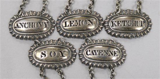 A set of five silver sauce labels by Reily & Storer;